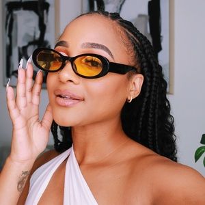 Small oval black sunglasses with yellow tint